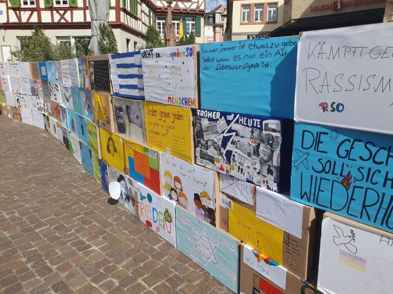 Auf dem Bild sieht man eine Wand mit Plakaten